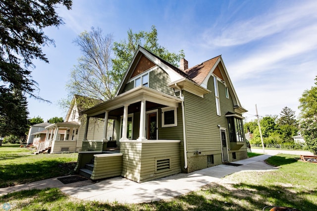 807 4th St S, Moorhead, MN 56560 - view of property exterior with covered porch, a chimney, and a yard