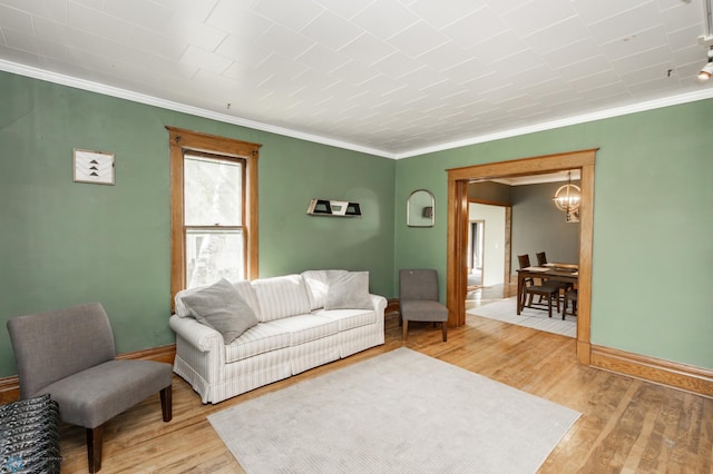 807 4th St S, Moorhead, MN 56560 - living room with crown molding, light wood-style floors, baseboards, and a chandelier