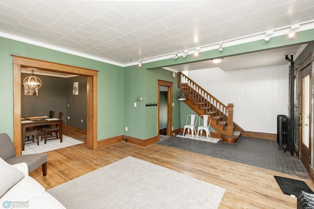 807 4th St S, Moorhead, MN 56560 - living area featuring track lighting, wood finished floors, baseboards, stairs, and crown molding