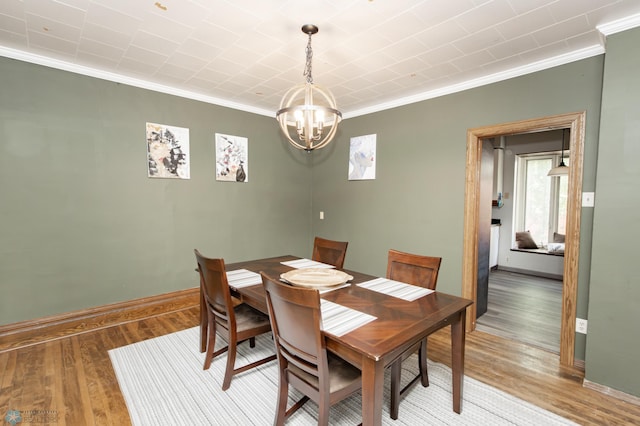 807 4th St S, Moorhead, MN 56560 - dining area featuring crown molding, a chandelier, wood finished floors, and baseboards
