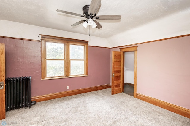807 4th St S, Moorhead, MN 56560 - unfurnished bedroom featuring radiator, carpet, baseboards, lofted ceiling, and a ceiling fan