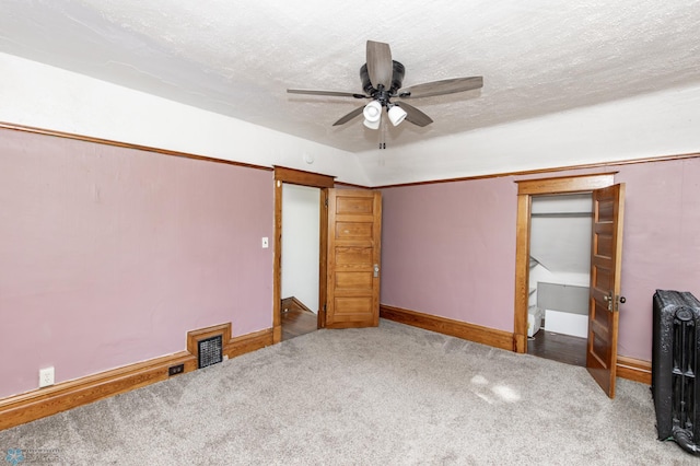 807 4th St S, Moorhead, MN 56560 - unfurnished bedroom featuring carpet floors, baseboards, ceiling fan, and radiator