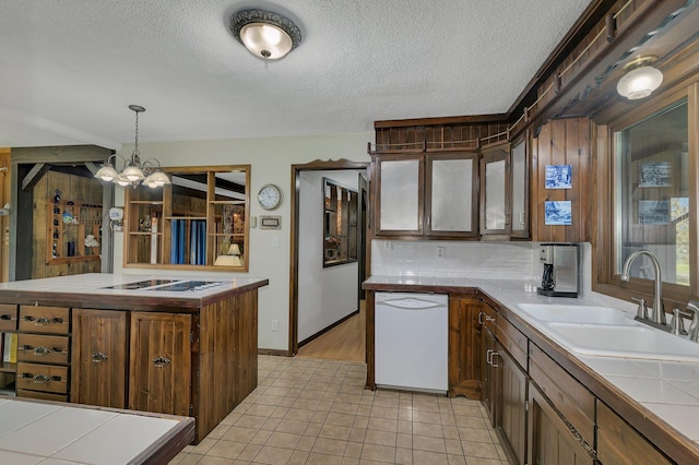 kitchen with sink, hanging light fixtures, light tile patterned floors, white appliances, and a kitchen island