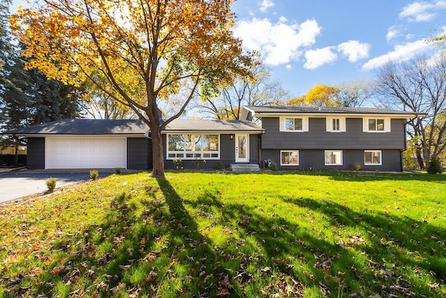 split level home with a front yard and a garage