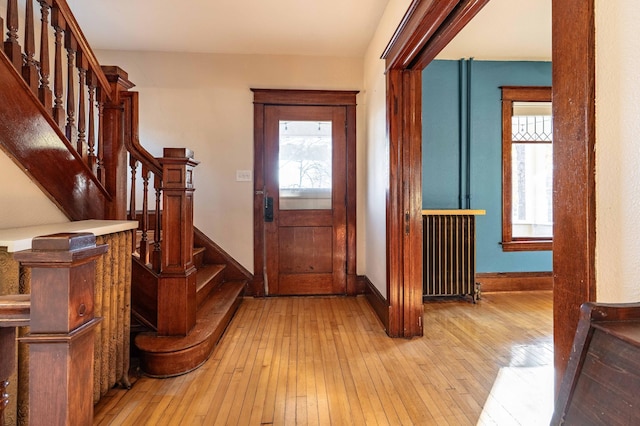 foyer featuring light hardwood / wood-style flooring and a healthy amount of sunlight