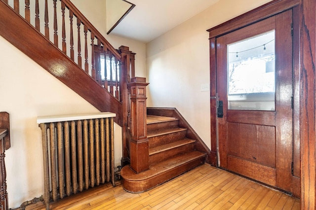 foyer featuring radiator heating unit and light wood-type flooring