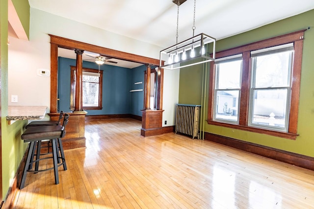 dining room with ceiling fan, a healthy amount of sunlight, and light wood-type flooring