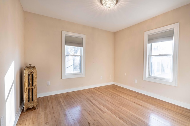 unfurnished living room featuring light hardwood / wood-style floors and a notable chandelier