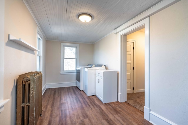 laundry room featuring radiator heating unit, dark hardwood / wood-style flooring, wooden ceiling, separate washer and dryer, and crown molding