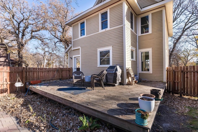 back of house featuring a wooden deck