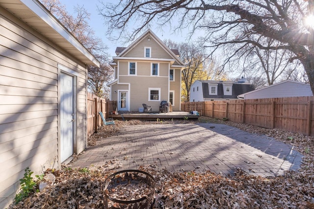 back of property featuring a patio area and a deck