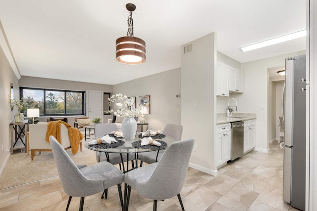 carpeted dining space with sink