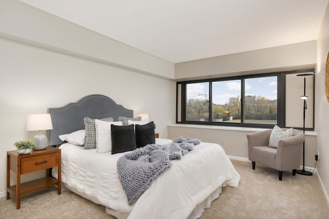 bedroom featuring light carpet