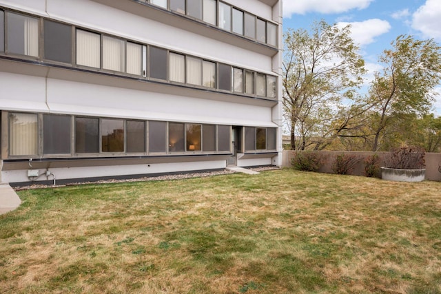 exterior space featuring a yard and a sunroom