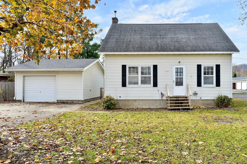 view of front of property with a front yard and a garage