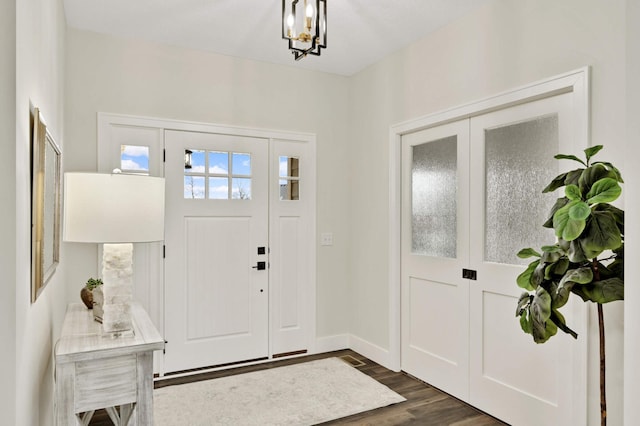 entryway featuring dark hardwood / wood-style floors and a chandelier