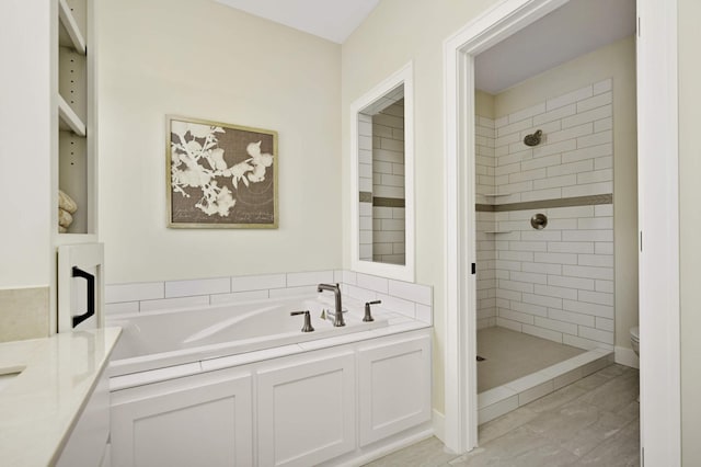 bathroom with tile patterned floors, toilet, and independent shower and bath