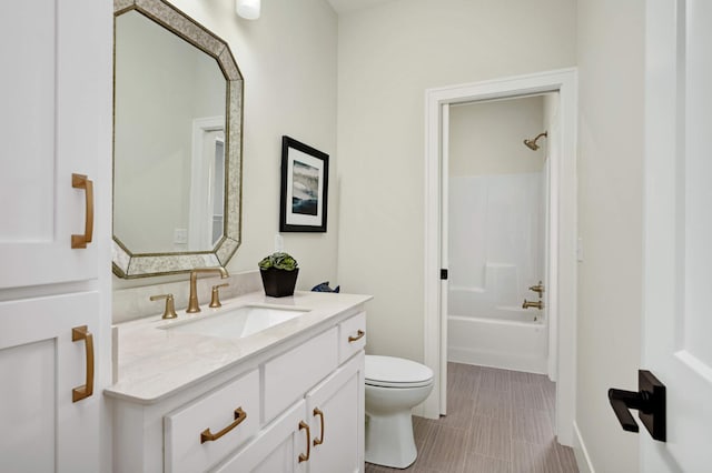 full bathroom with toilet, vanity, and  shower combination