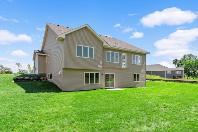 back of house featuring a lawn