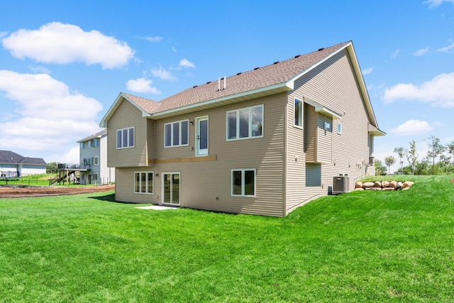 rear view of property with a yard and cooling unit