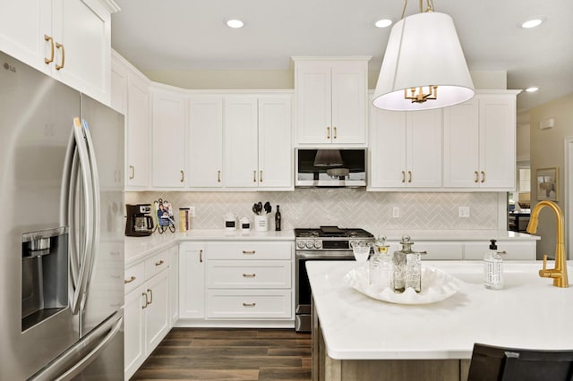 kitchen featuring stainless steel appliances, dark wood-type flooring, white cabinetry, and decorative light fixtures