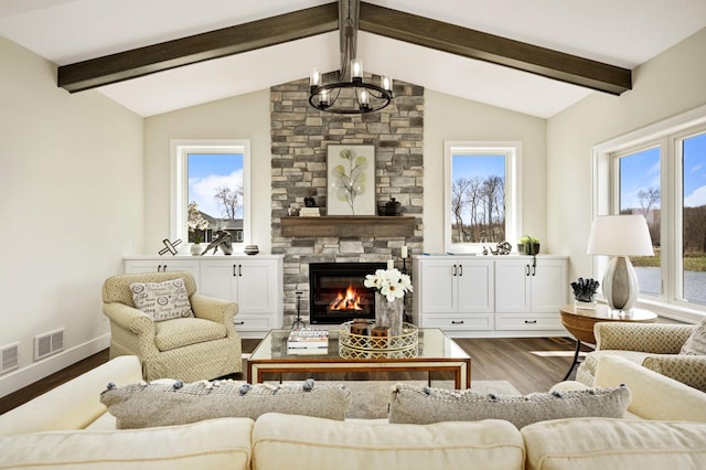 living room featuring hardwood / wood-style floors, vaulted ceiling with beams, and a fireplace