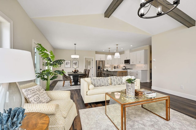 living room featuring dark hardwood / wood-style flooring, a chandelier, and vaulted ceiling with beams