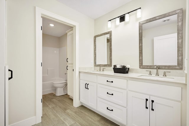 bathroom featuring hardwood / wood-style flooring, vanity, and toilet