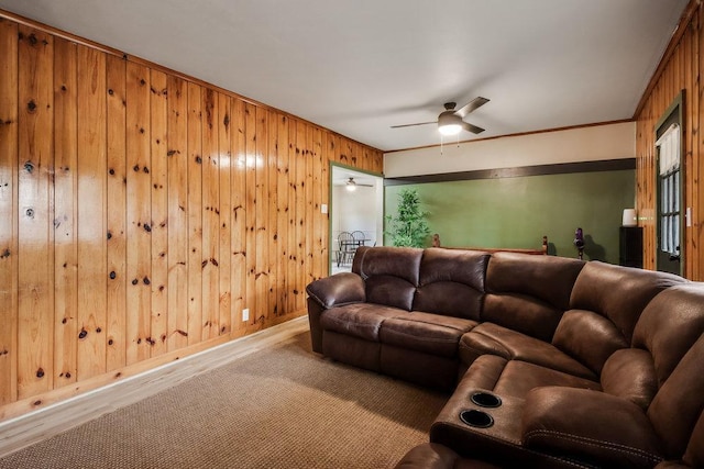 living room with wooden walls and ceiling fan