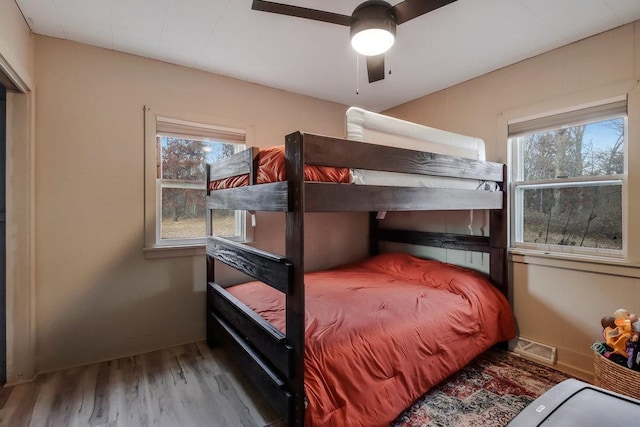 bedroom with ceiling fan and wood-type flooring