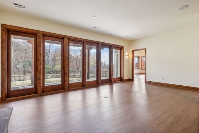 entryway with a healthy amount of sunlight and hardwood / wood-style floors