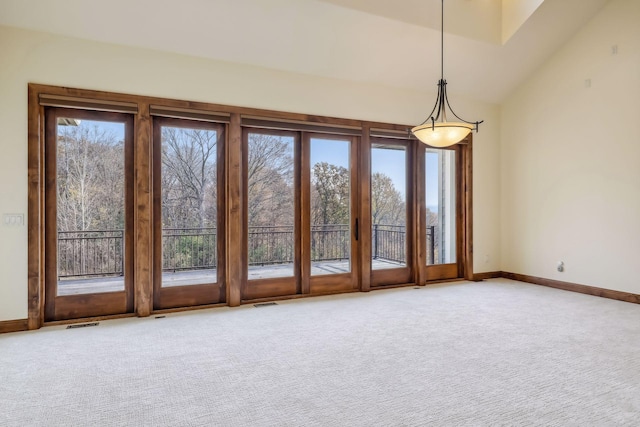 unfurnished room featuring lofted ceiling and carpet