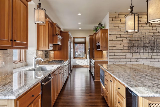 kitchen featuring tasteful backsplash, appliances with stainless steel finishes, pendant lighting, and light stone counters