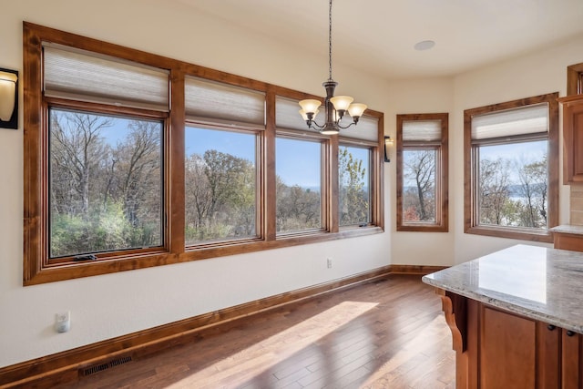 unfurnished sunroom featuring a chandelier