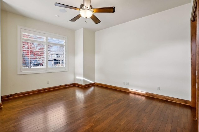 spare room with ceiling fan and dark hardwood / wood-style flooring