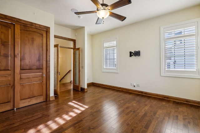 unfurnished bedroom with dark hardwood / wood-style flooring and ceiling fan