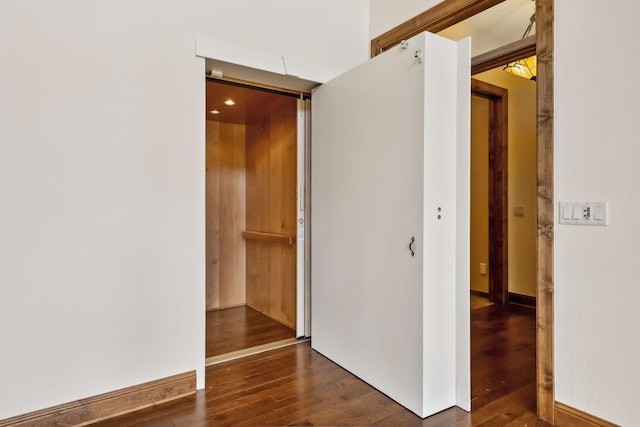 corridor featuring dark wood-type flooring