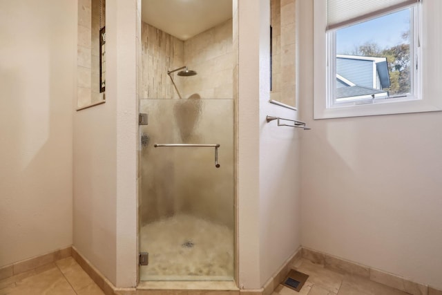 bathroom featuring tile patterned floors and an enclosed shower