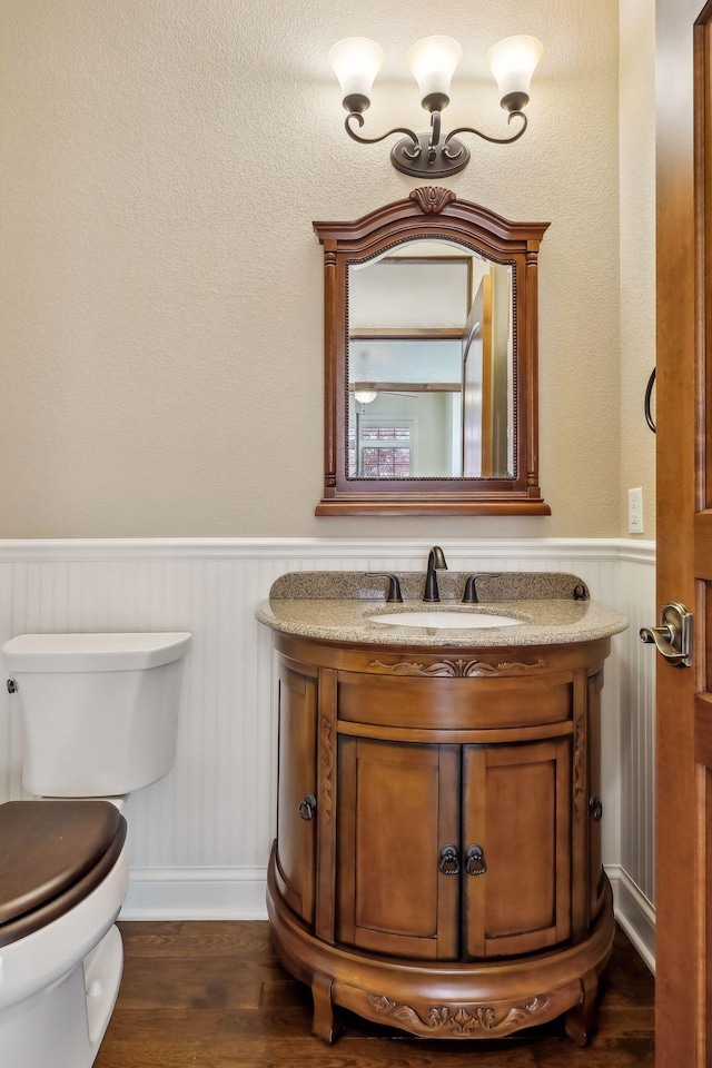 bathroom with vanity, hardwood / wood-style floors, and toilet