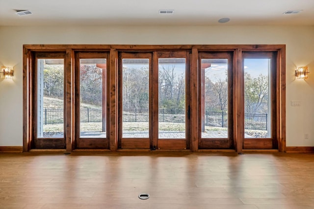 entryway featuring a healthy amount of sunlight and light hardwood / wood-style flooring