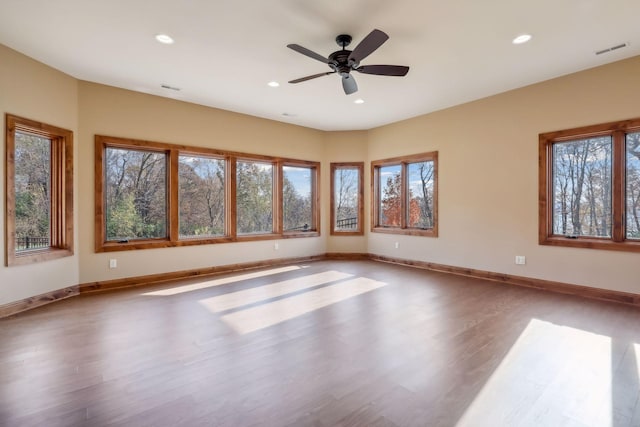 spare room featuring hardwood / wood-style floors and ceiling fan