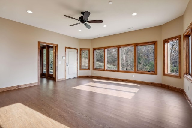 interior space with dark hardwood / wood-style flooring and ceiling fan