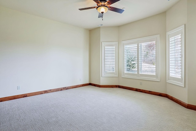 carpeted empty room featuring ceiling fan