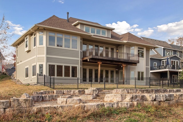 rear view of property with a balcony