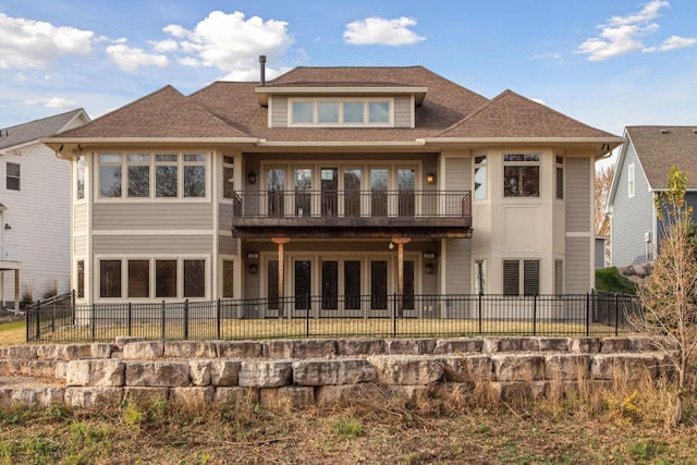 back of property with a balcony