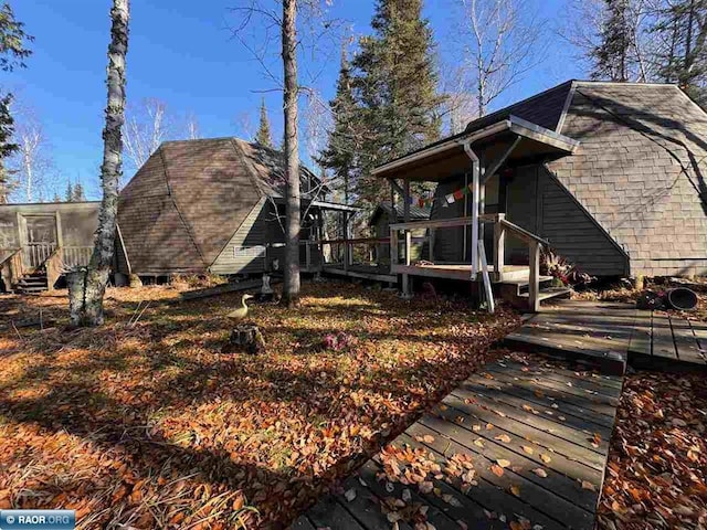 view of yard featuring a wooden deck and a sunroom