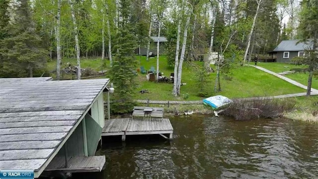 dock area with a water view and a lawn
