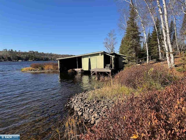 exterior space with a boat dock and a water view