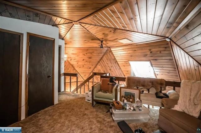 living area featuring carpet flooring, an upstairs landing, wooden walls, wooden ceiling, and vaulted ceiling