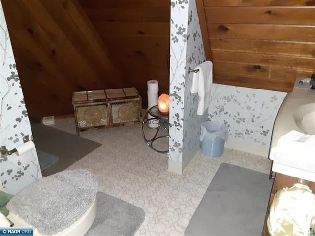 bathroom with vanity and wood walls